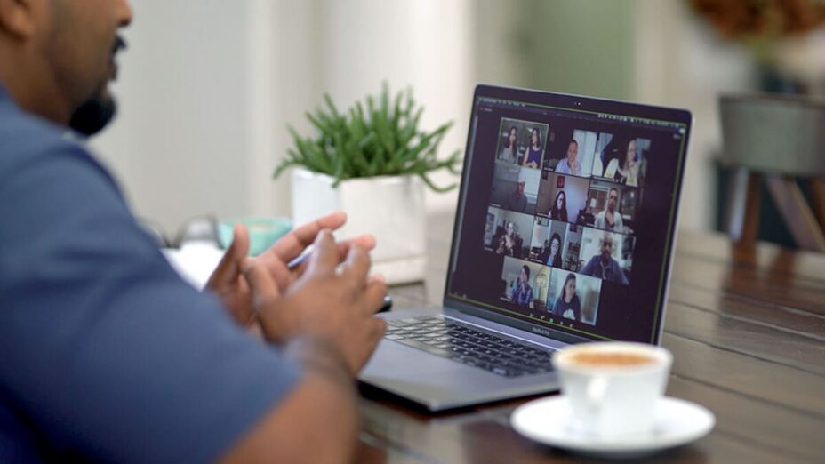 A man attending a live virtual Adaptive Listening training on his laptop.