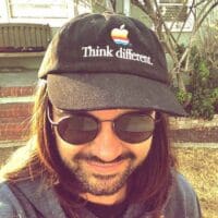 man in sunglasses wearing an apple hat