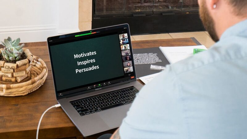 A person watching a virtual presentation on their laptop.