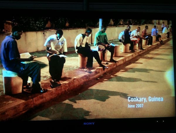Bill Gates Presentation Slide: Students doing their homework on the street where they have access to light