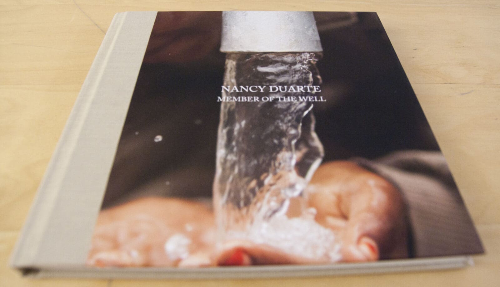 A keepsake book with photos taken in the village where Duarte's well is located.