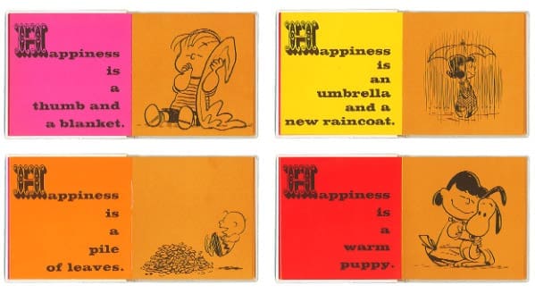 Several pages in the book with the statement "Happiness is" in pink, yellow, orange, and red