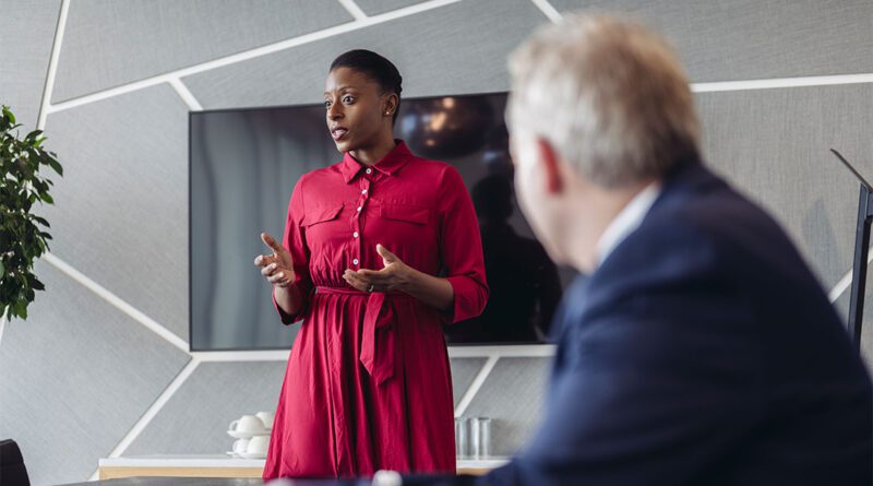 Header image for "Tips to craft and nail your upcoming executive presentation" featuring a person delivering a high-level presentation to senior C-suite leaders.