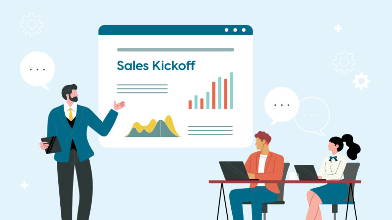 A sales leader presents a kickoff slide with growth charts to two sales reps on laptops, showing sales enablement in action.
